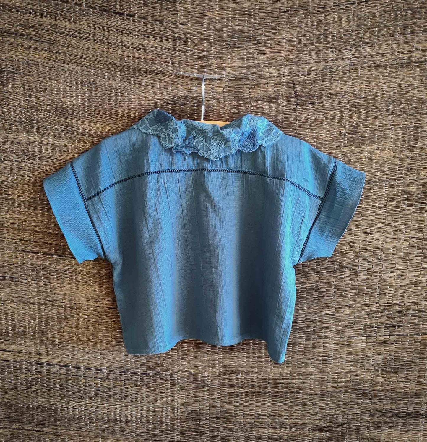 The back view of The Kefi House kids' blue short-sleeve top with a charming lace-edged Peter Pan collar, designed for comfort and style.