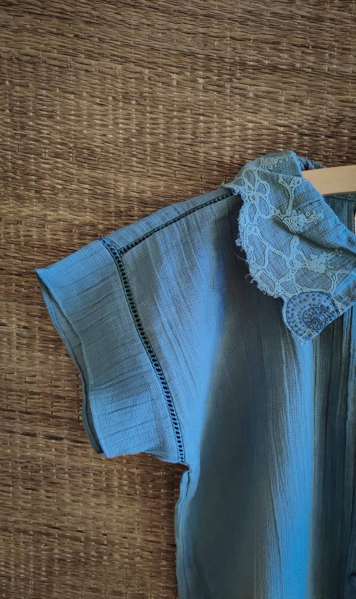 Close-up of The Kefi House kids' blue short-sleeve top with a charming lace-edged Peter Pan collar, designed for comfort and style. with the lace details.