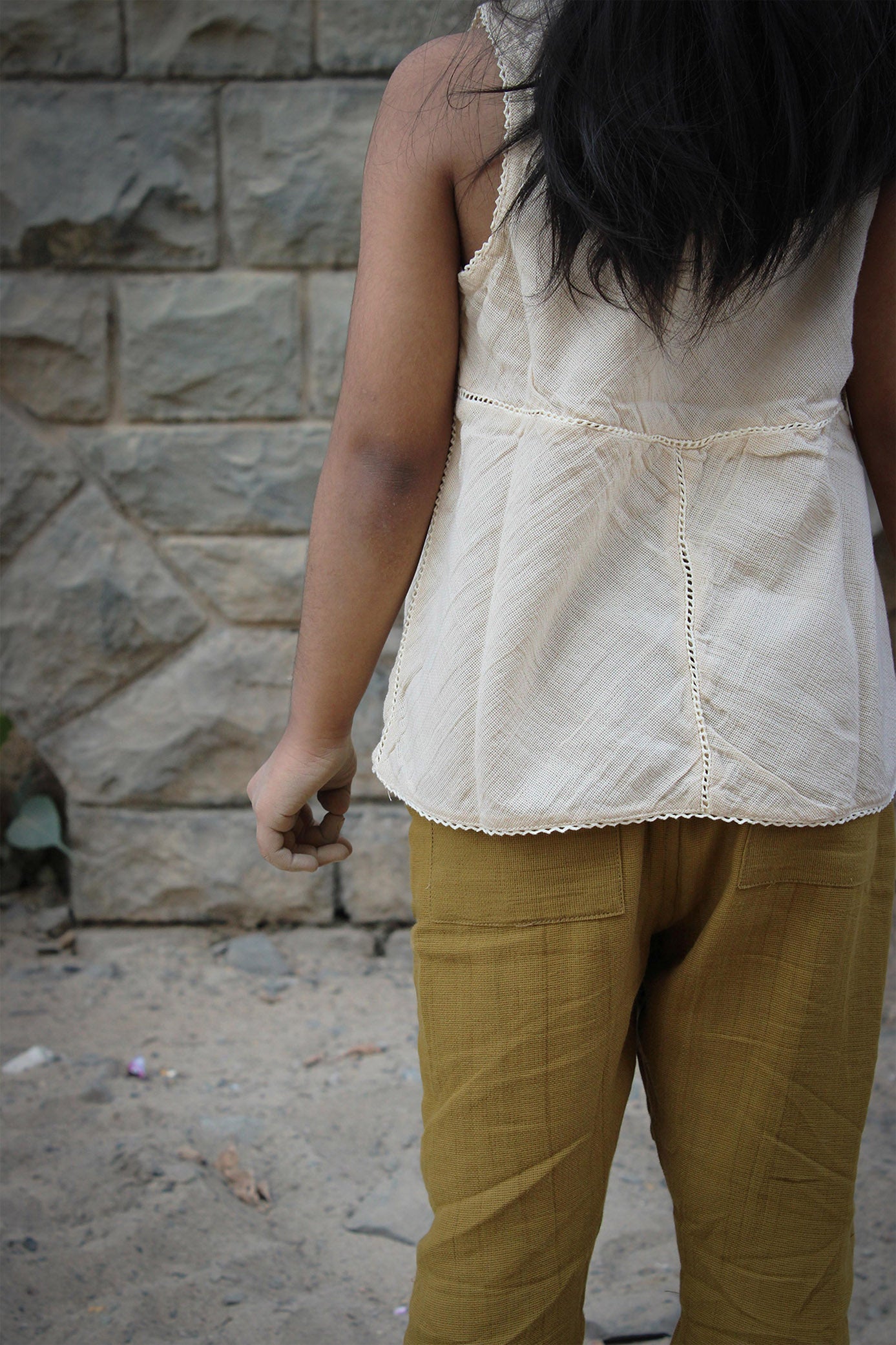 A girl wearing off-white ganjees paired with olive pants