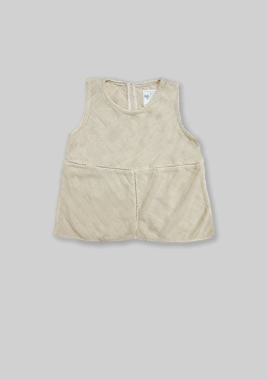 Off white sleeveless top on a gray background