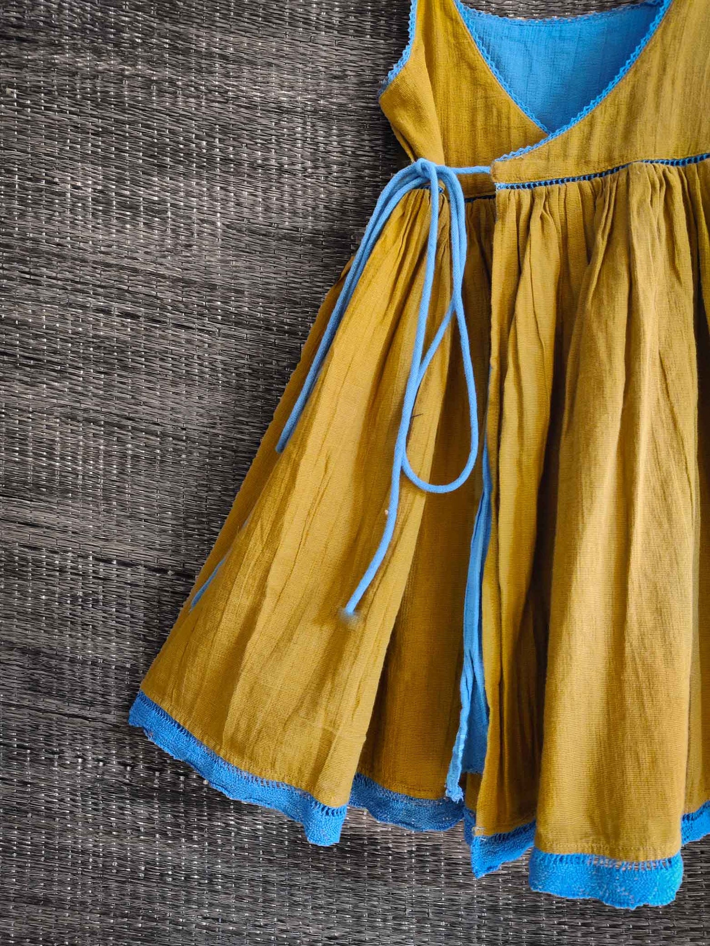 Close-up of lace detailing on olive side of dress