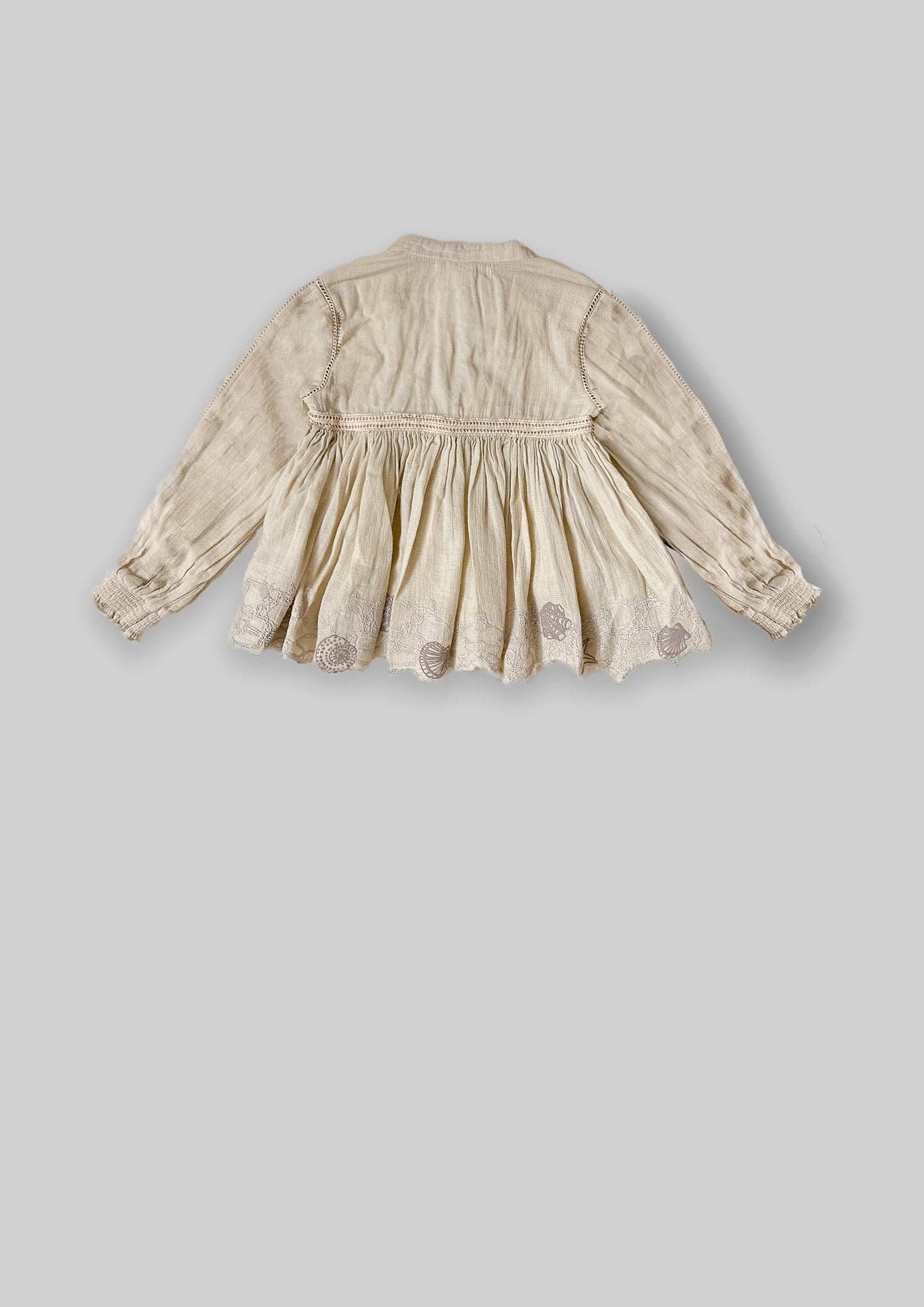 Back of Off-white top with full sleeves and lace detail with shell-inspired lace details