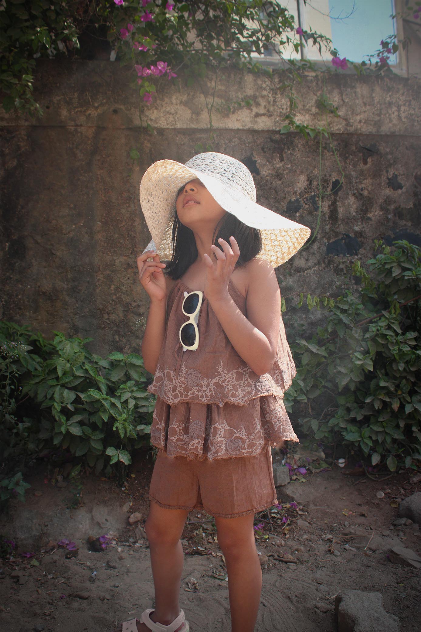 Playsuit - Mud TheKefiHouse The Kefi House kids' brown summer outfit featuring tiered ruffles and lace detail, paired with a sun hat, ideal for sunny days.