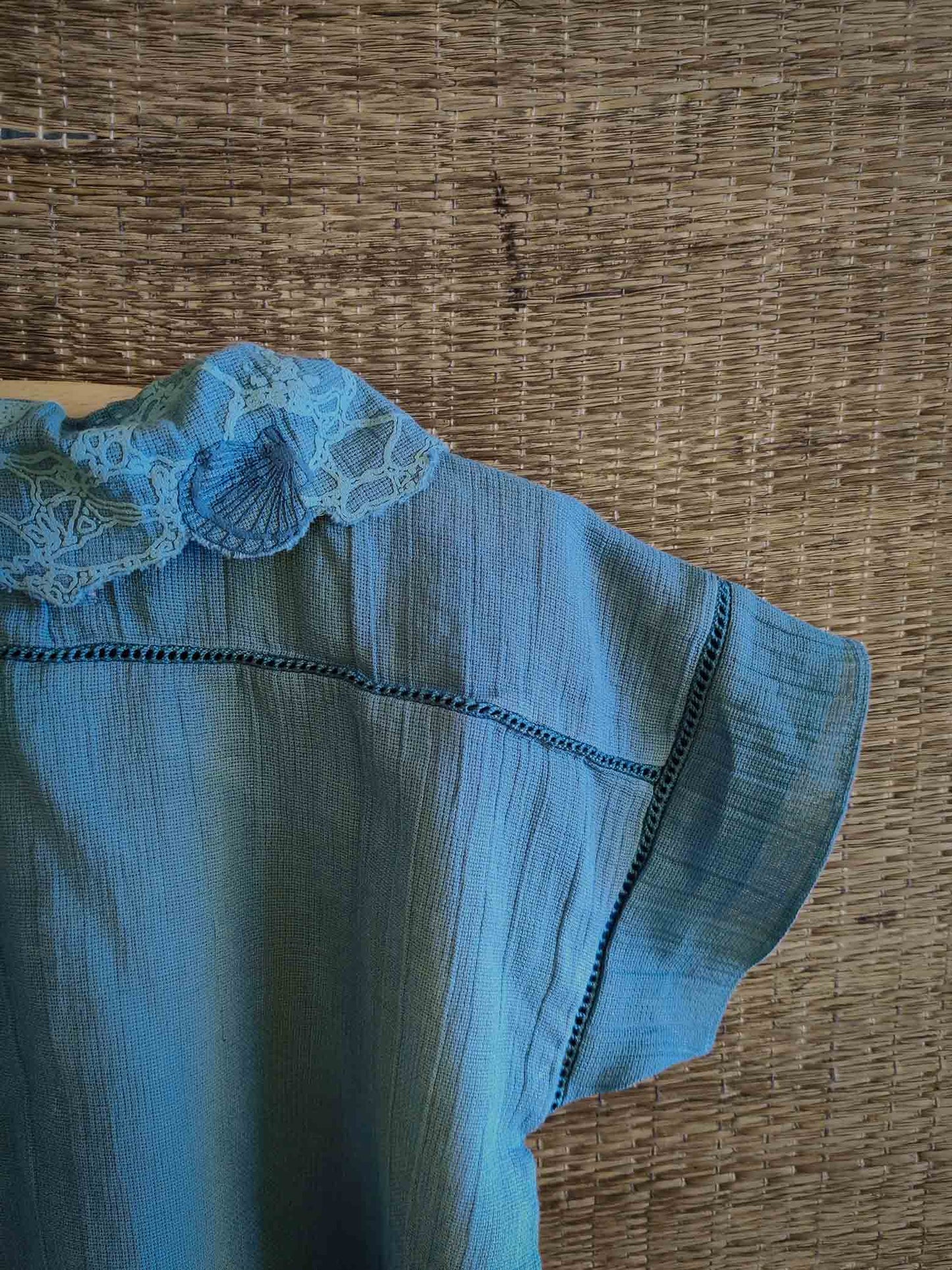 The Kefi House kids' blue short-sleeve top with a charming lace-edged Peter Pan collar, designed for comfort and style.
