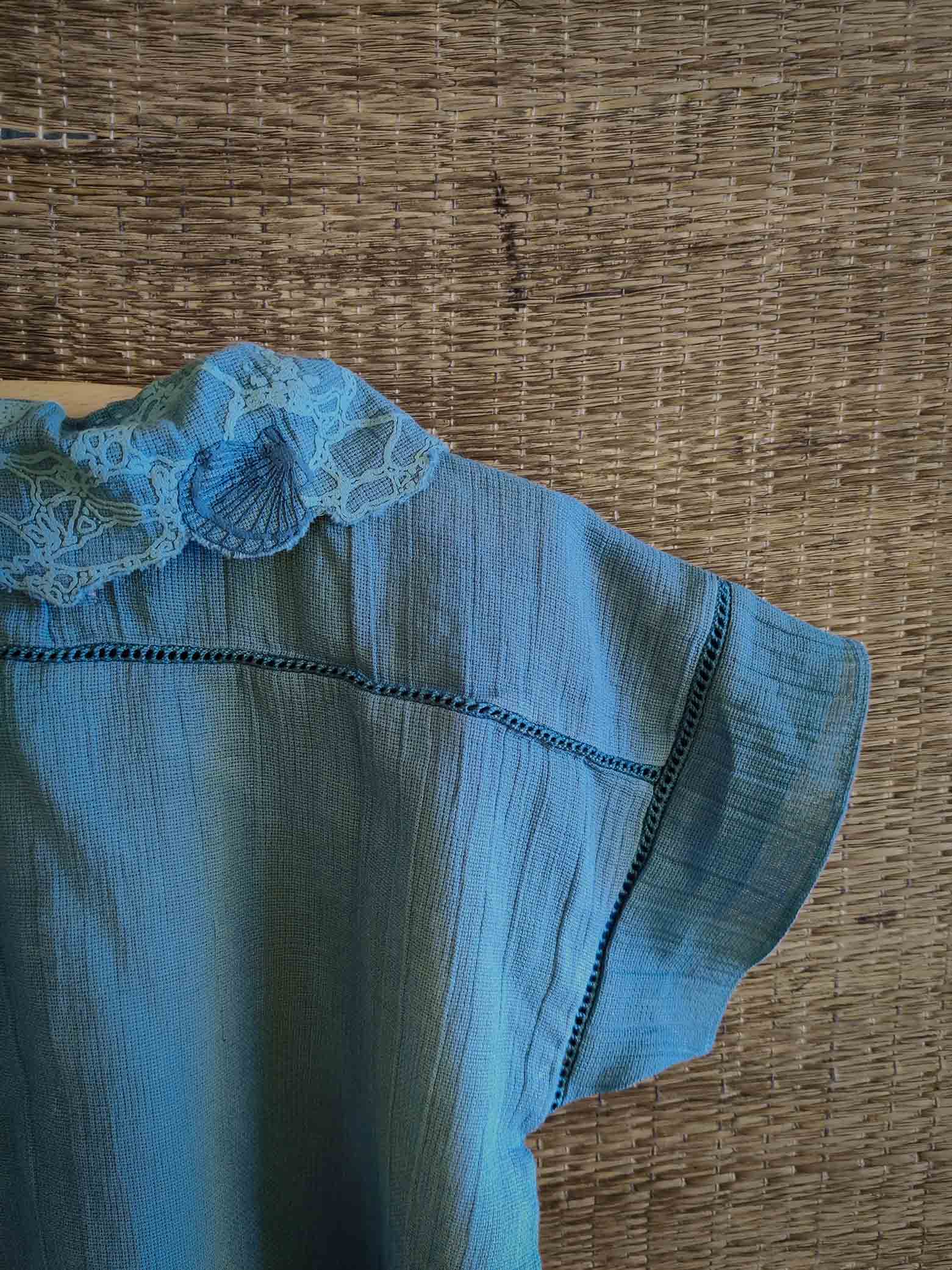 The Kefi House kids' blue short-sleeve top with a charming lace-edged Peter Pan collar, designed for comfort and style.