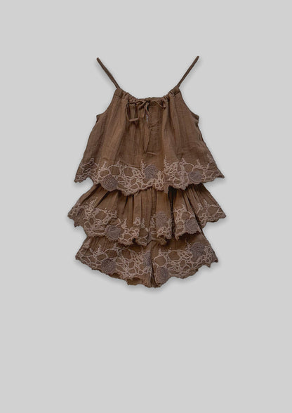 Brown tiered Jumpsuit with lace details on a light gray background