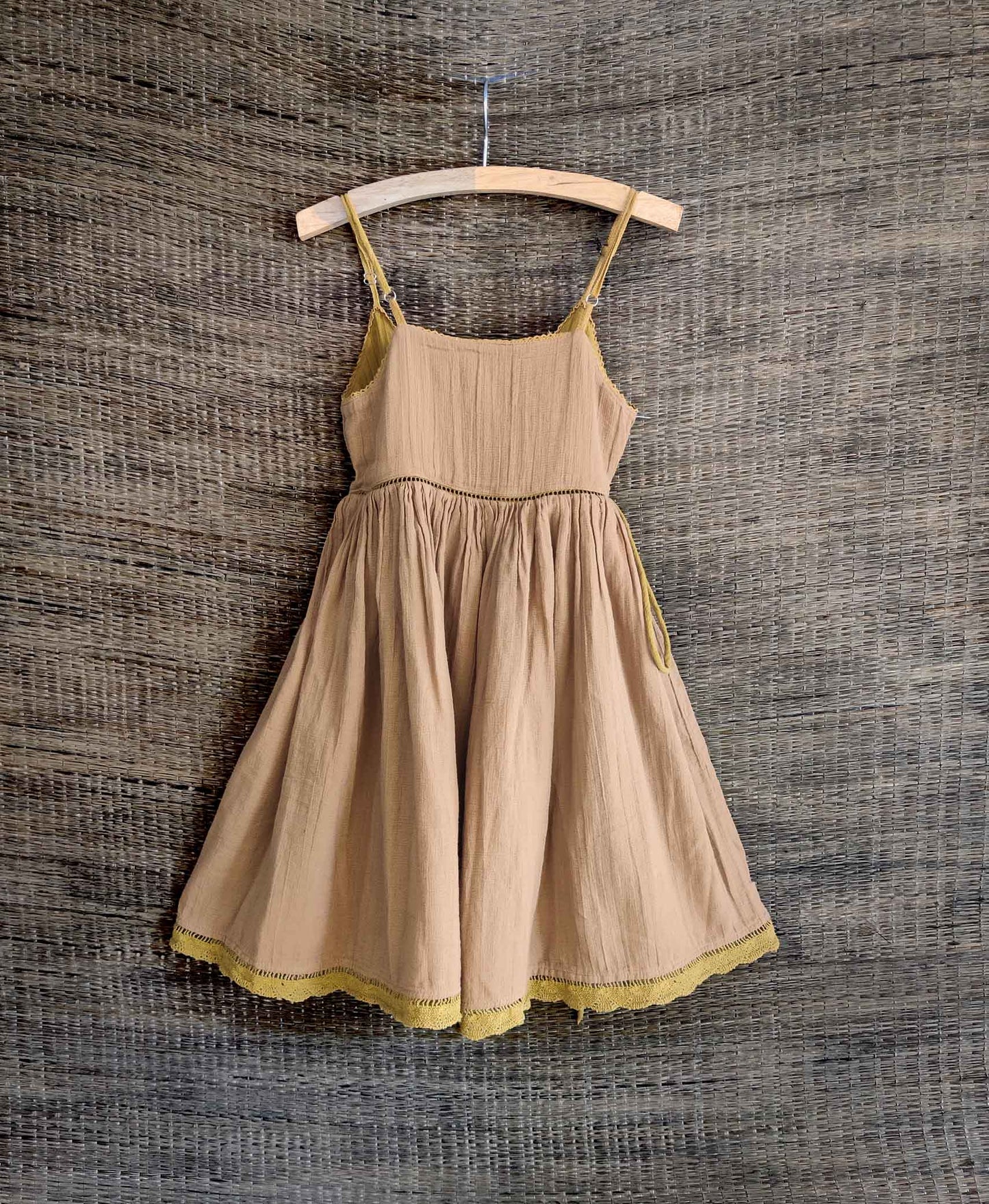 Back view of reversible dress showing the brown side with delicate lace details