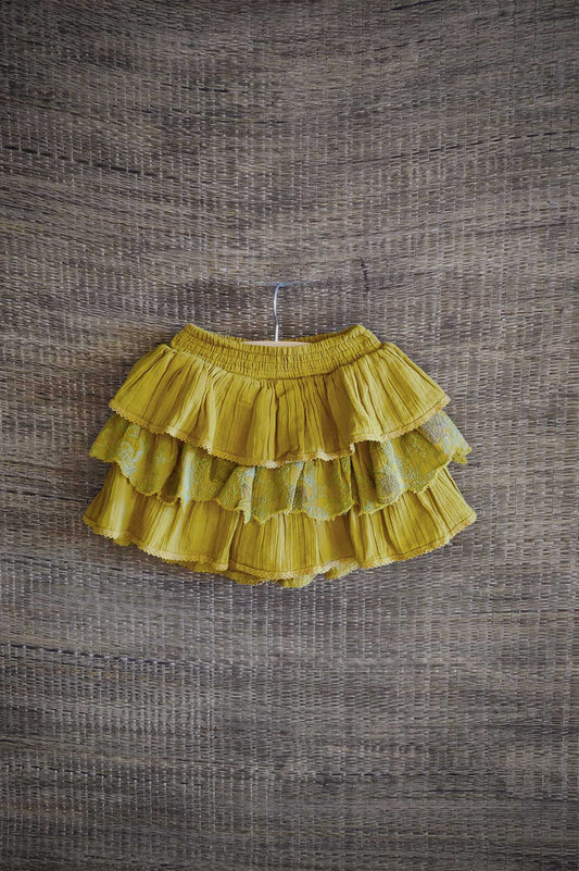 Tiered mustard yellow cotton skort for girls with embroidered lace detailing — sustainable and comfy kidswear for ages 2–10.
